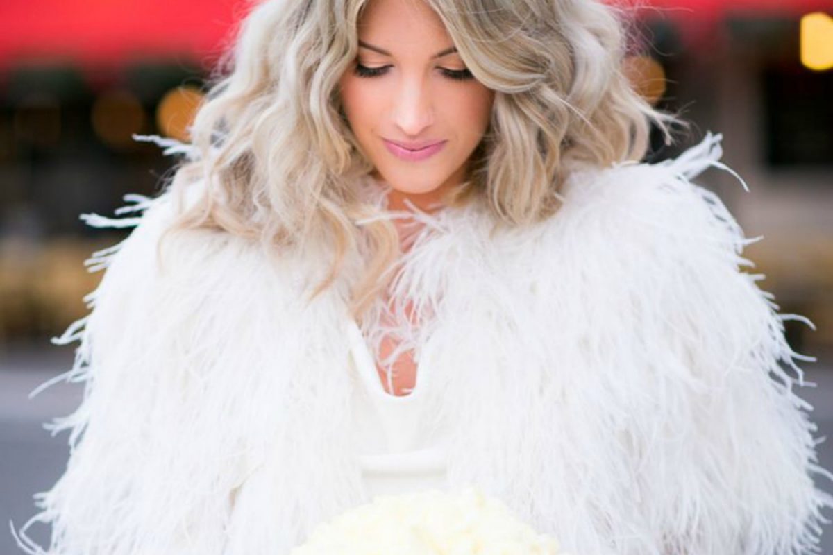 Bride wearing a feather bridal coat