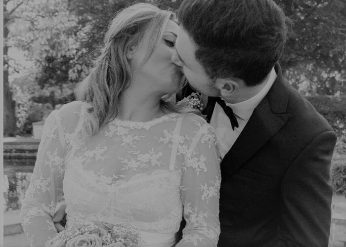 bride and groom kissing - bride wearing a lace bridal top