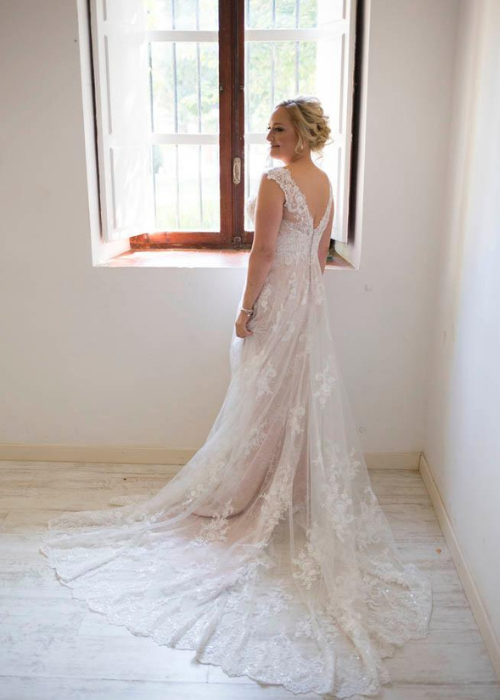 a bride standing by the window