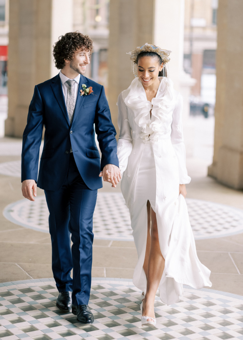 couple holding hands and walking in london city wedding