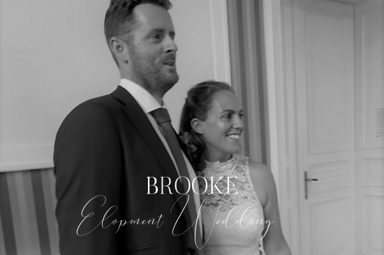 Custom Made Wedding Dresses London. Black and white Photo of bride and groom during celebrations. Bride wears a bespoke mini feather wedding dress