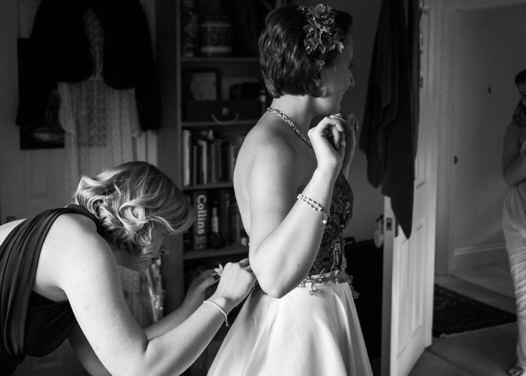 Real bride getting into her  restyled heirloom wedding dress  