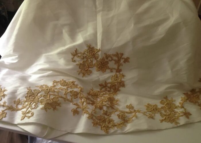 Vintage lace not repurposed but used intentionally to add details to the train of a modern wedding dress